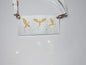 a white bag with gold dragons on it